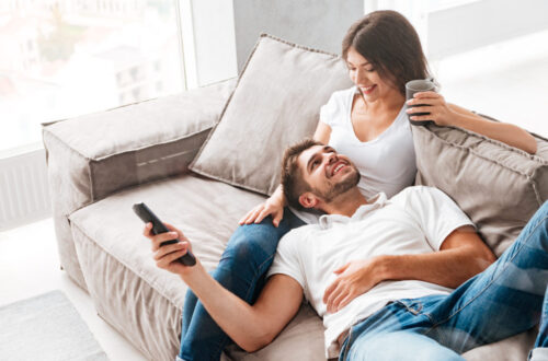 Romantic couple goals: New couple cuddling on the sofa